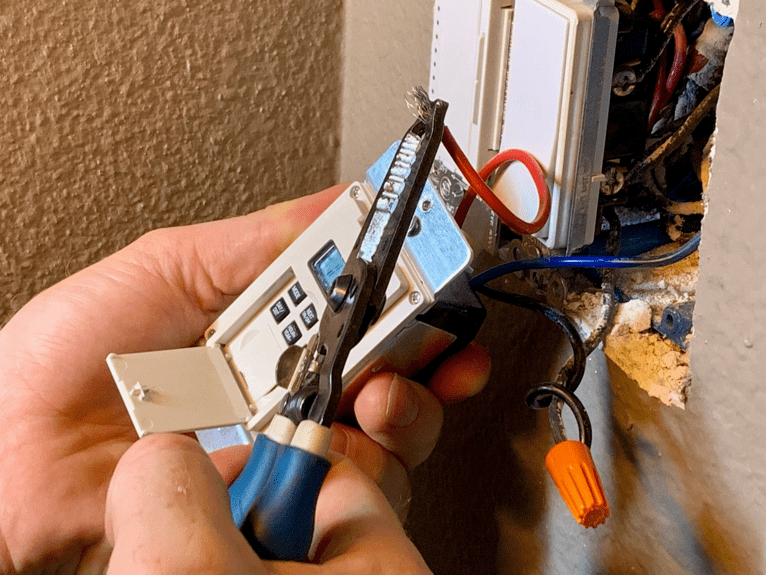electrician using a test meter on wiring 