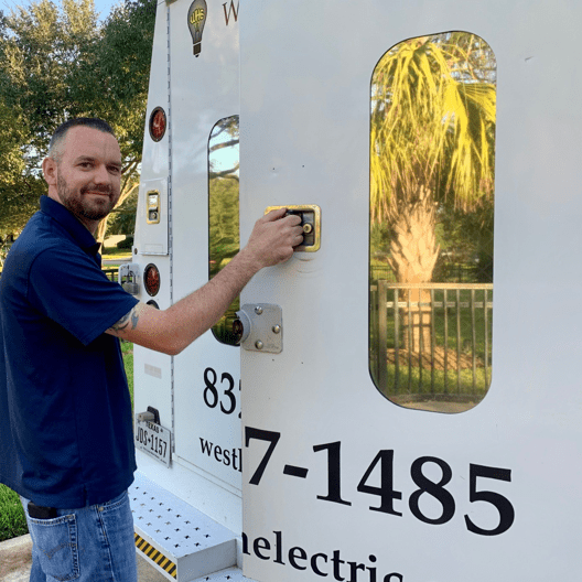 Technician opening the backdoor of a company truck while looking at the camera 